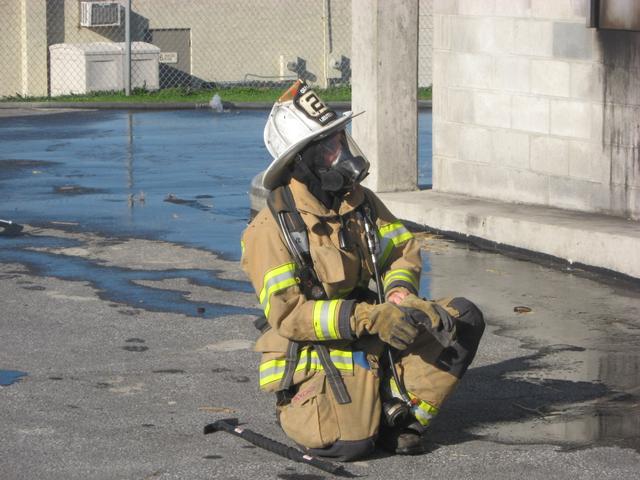 Lieutenant Greg Paxson prepares to go inside.